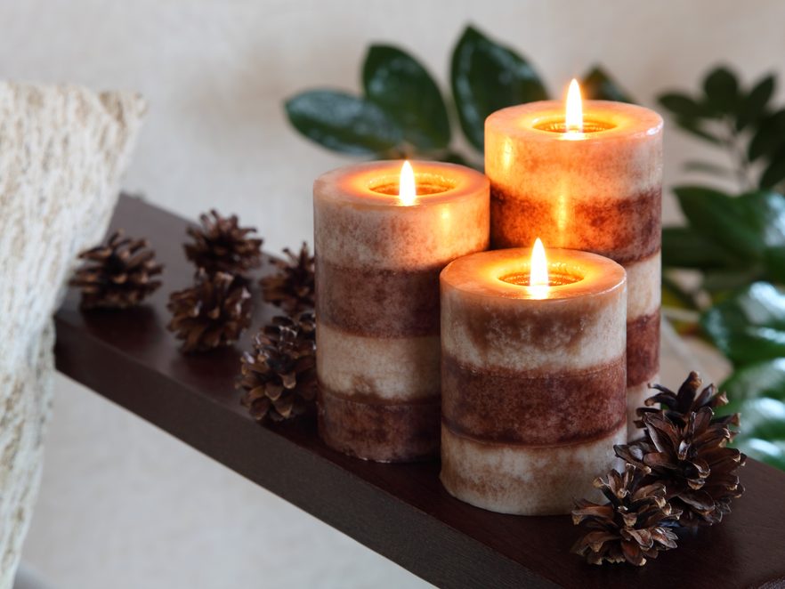 Three burning pillar candles