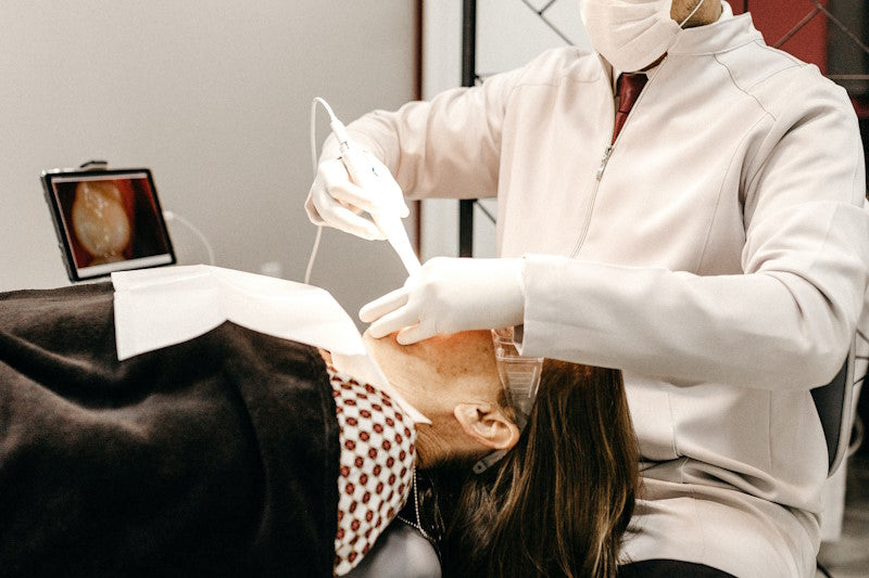 Older woman getting her teeth cleaned