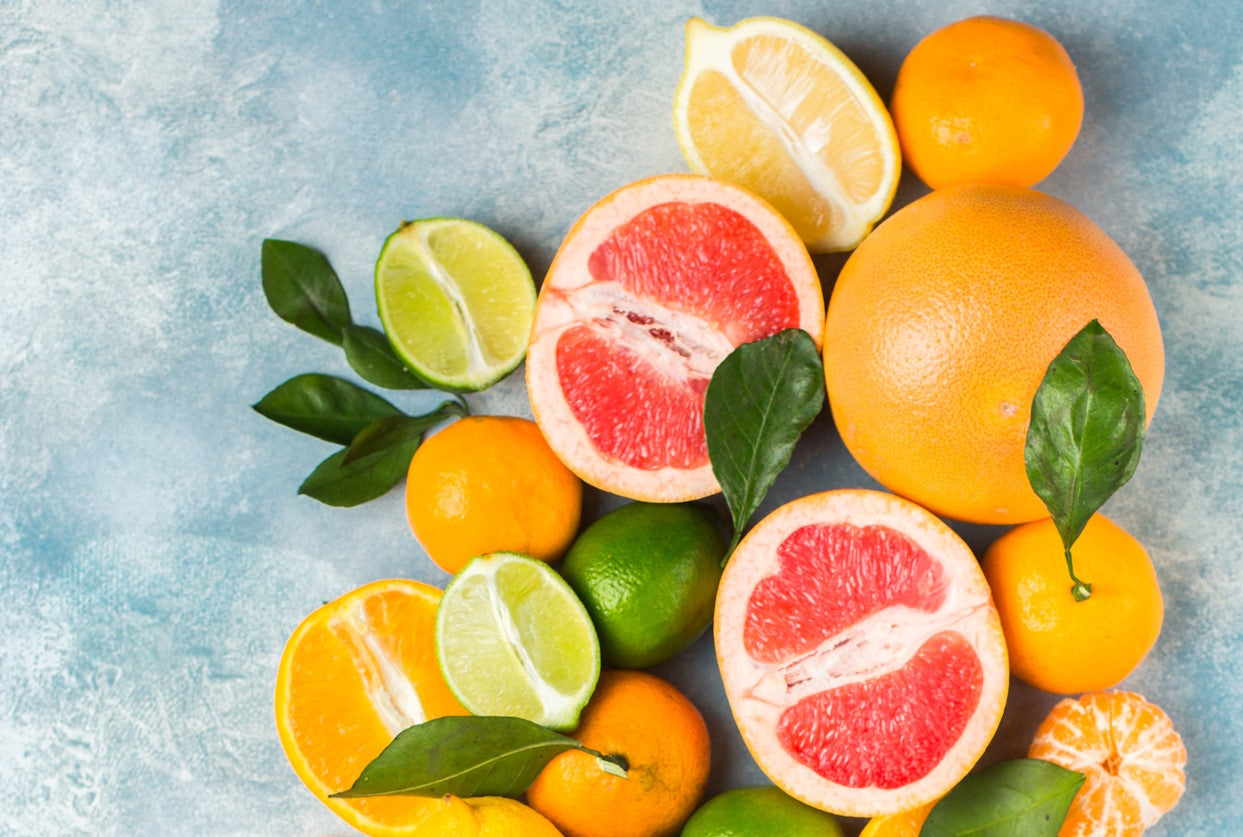 Sliced and whole citrus fruits