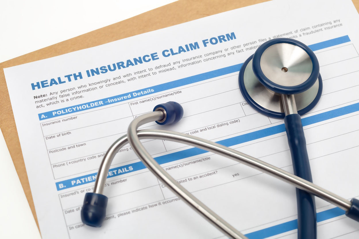 Health insurance claim form with a stethoscope on top of it