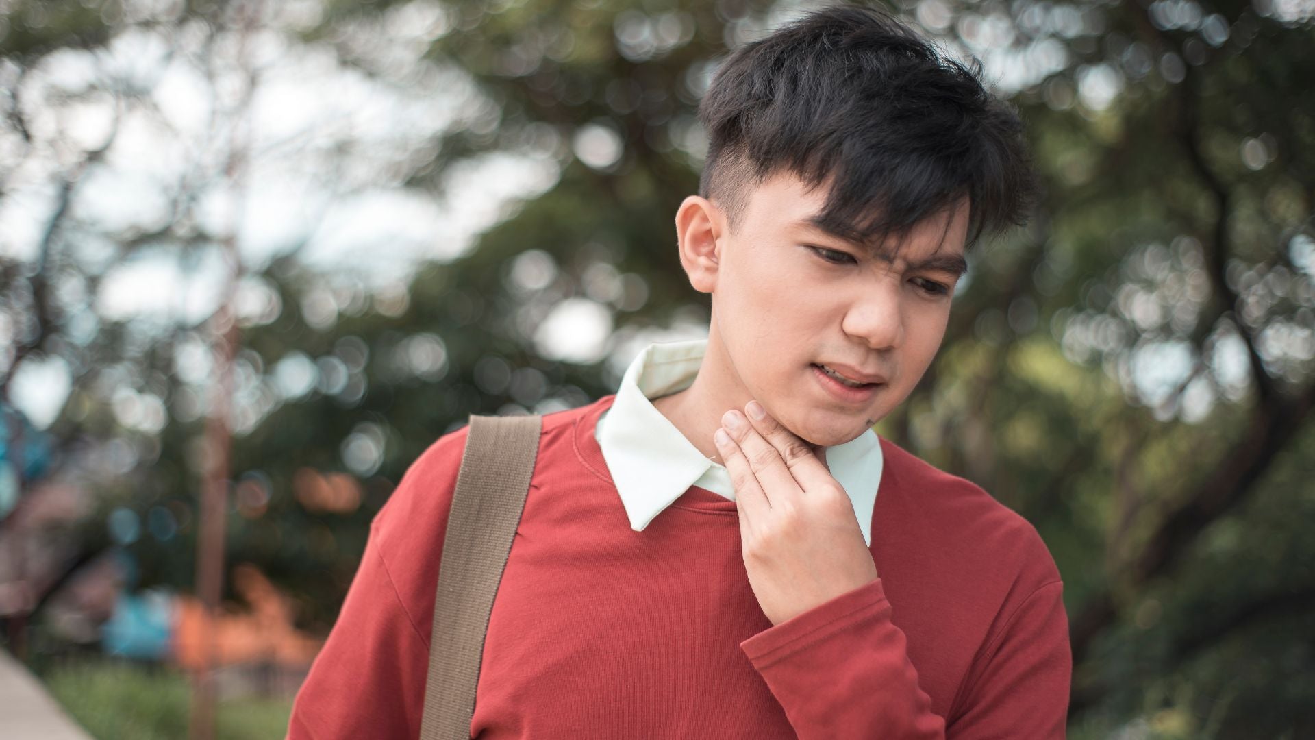 Young man with itchy throat