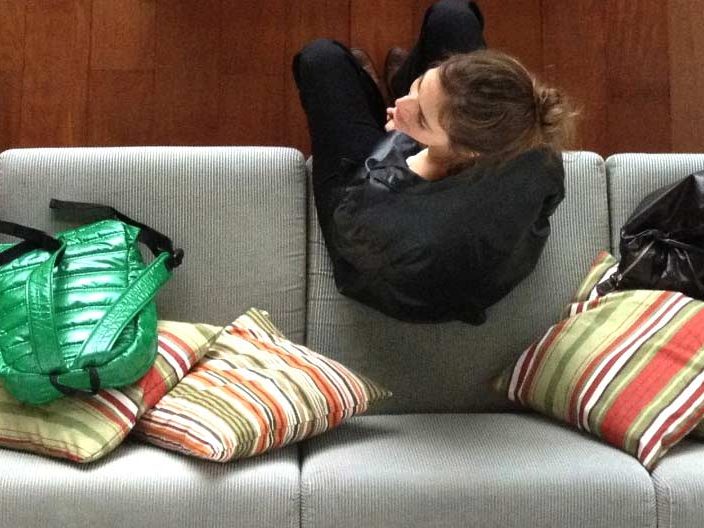 Overhead shot of woman on couch with couch pillows