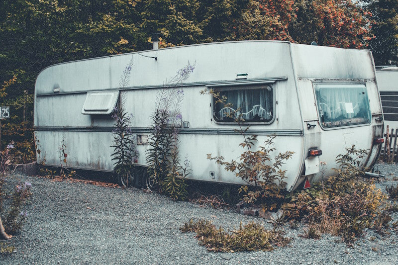 Camping trailer that looks old and dirty