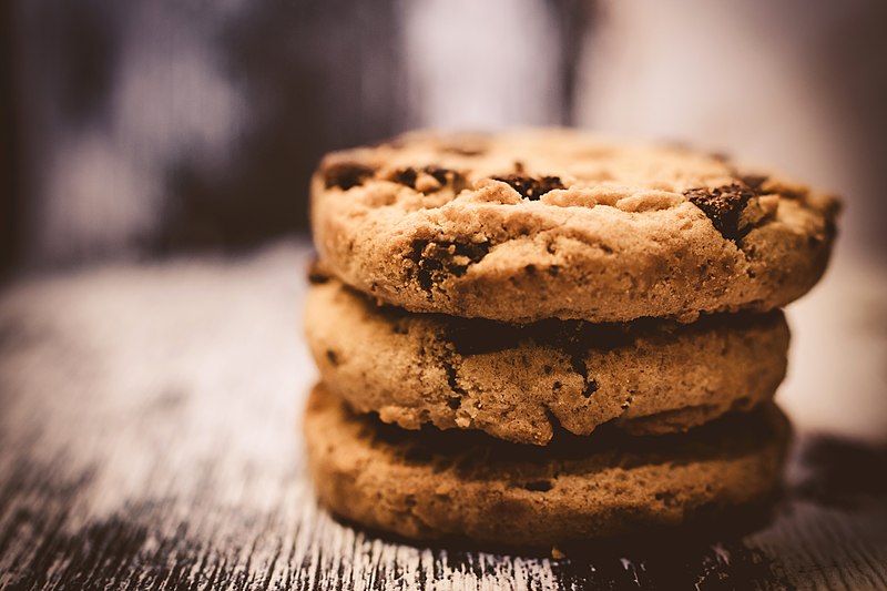 A stack of three chocolate chip cookies