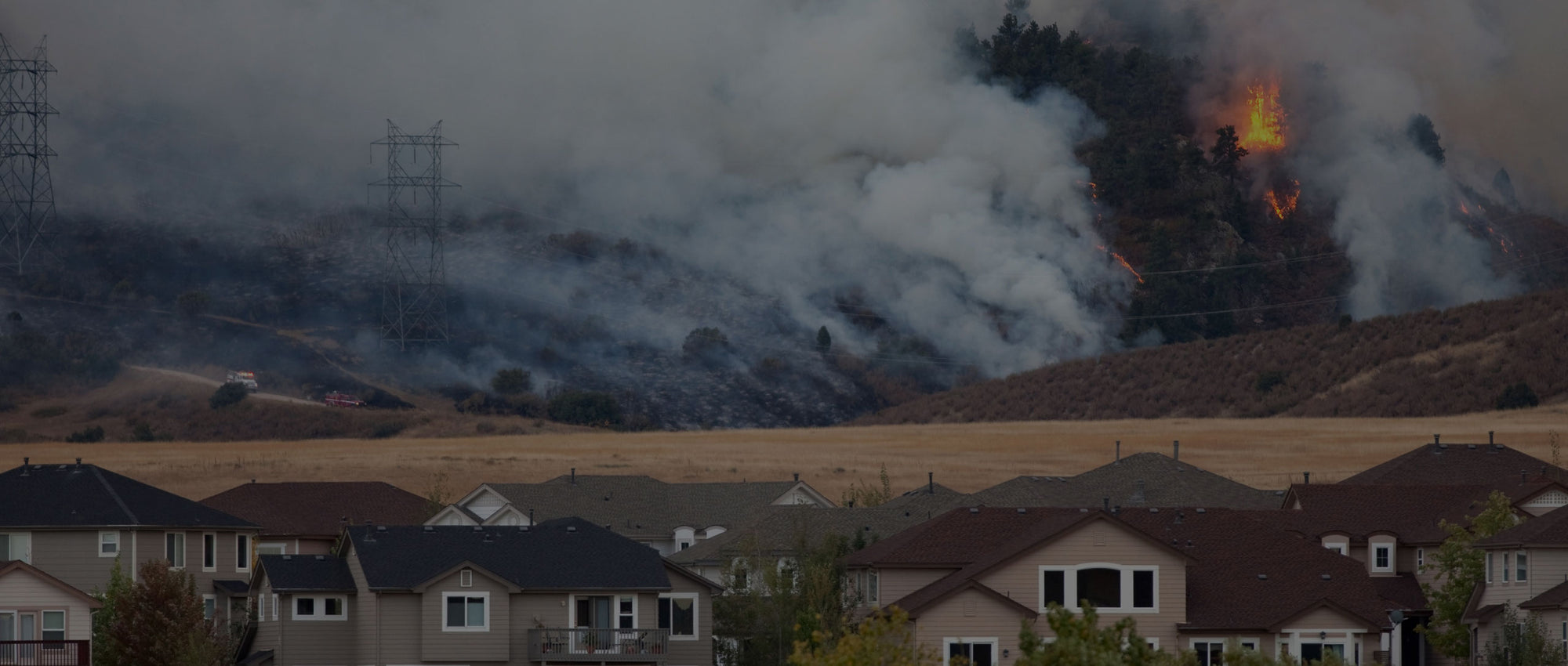 Wildfire smoke billowing near homes