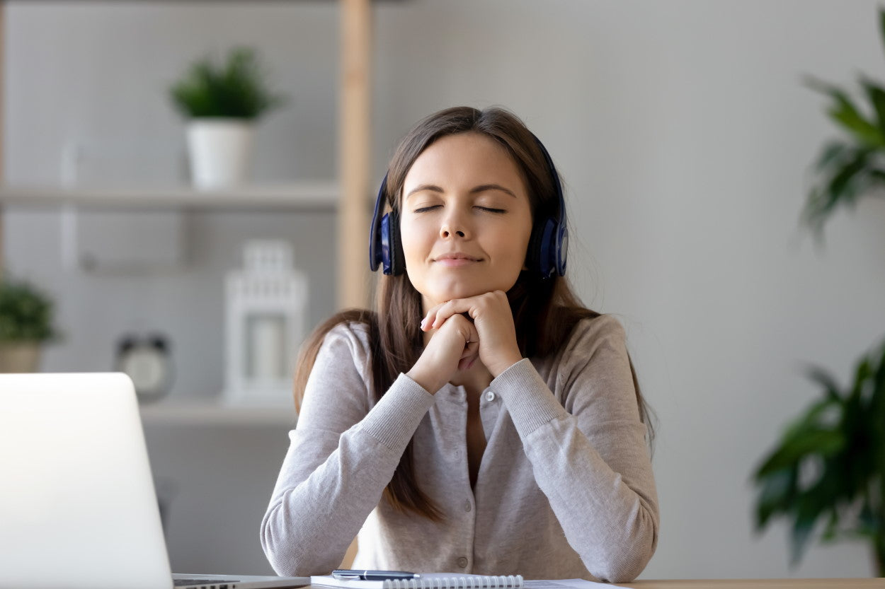 Content woman listen to music through headphones